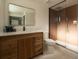 Bathroom featuring modern vanity with quartz countertops, wooden drawers, and a glass-enclosed shower at 4631 Zuni St, Denver, CO 80211