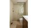 A modern bathroom with a walk-in shower, marble flooring, and sleek fixtures at 4631 Zuni St, Denver, CO 80211