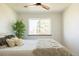 A bright and airy bedroom with a ceiling fan, a large window, and cozy decor at 4631 Zuni St, Denver, CO 80211