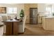 A dining area featuring a wooden table with white linen chairs, and modern appliances at 4631 Zuni St, Denver, CO 80211
