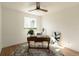 Sunlit home office with wooden desk, decor, art, a gray rug and bright window at 4631 Zuni St, Denver, CO 80211