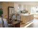 An open-concept kitchen with modern appliances, light wood cabinets, and dining area at 4631 Zuni St, Denver, CO 80211
