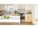 A bright kitchen with a gas range, white countertops, and tiled backsplash at 4631 Zuni St, Denver, CO 80211
