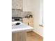 A stylish kitchen featuring an oven and a white quartz countertop with wooden cabinets at 4631 Zuni St, Denver, CO 80211