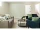 Neutral living room boasting two sofas, two blue armchairs, and a stylish black coffee table at 4631 Zuni St, Denver, CO 80211