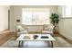 Cozy living room with seating area, natural light, and warm wood flooring at 4631 Zuni St, Denver, CO 80211
