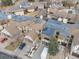 An aerial view of townhomes with garages and some landscaping in a residential neighborhood at 4250 S Olive St # 108, Denver, CO 80237