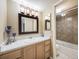 Bathroom featuring a vanity with a granite countertop, updated lighting, and tile flooring at 4250 S Olive St # 108, Denver, CO 80237