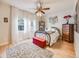 Charming bedroom featuring a decorative ceiling fan and natural light from a window at 4250 S Olive St # 108, Denver, CO 80237