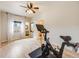 Spacious bedroom with a ceiling fan and hardwood flooring; an exercise bike sits in the corner at 4250 S Olive St # 108, Denver, CO 80237