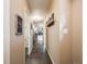 Hallway with tile floors and neutral walls, leading to various rooms at 4250 S Olive St # 108, Denver, CO 80237