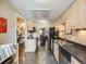 Kitchen featuring stainless steel appliances, tile floors, and views into the dining room at 4250 S Olive St # 108, Denver, CO 80237