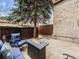 Inviting patio featuring comfortable blue cushioned seating around a modern fire pit table at 4250 S Olive St # 108, Denver, CO 80237