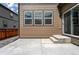 Inviting back patio with access to the backyard and sliding glass door entrance at 933 Canal West Dr, Brighton, CO 80603