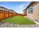 Beautiful backyard featuring a green lawn, stone area, and fenced perimeter at 933 Canal West Dr, Brighton, CO 80603