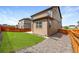 Well maintained backyard featuring a green lawn, gravel area, and a wooden fence at 933 Canal West Dr, Brighton, CO 80603