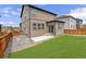 Backyard featuring a grassy area, a concrete patio and a fenced perimeter at 933 Canal West Dr, Brighton, CO 80603