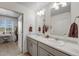 Bright bathroom features double vanity, ample storage, and a separate dressing area with exterior views at 933 Canal West Dr, Brighton, CO 80603