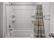 A clean and bright shower-tub combo with tiled walls and storage niches at 933 Canal West Dr, Brighton, CO 80603