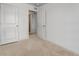 Bedroom featuring a door, neutral carpet, and ample wall space at 933 Canal West Dr, Brighton, CO 80603