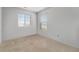 Bright bedroom featuring carpeted floors and two windows letting in natural light at 933 Canal West Dr, Brighton, CO 80603