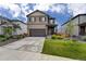 Charming two-story home with a well-maintained lawn, two-car garage, and neat landscaping at 933 Canal West Dr, Brighton, CO 80603