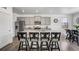 Well-equipped kitchen with stainless steel appliances, gray cabinets, granite countertops, island with bar seating, and wood floor at 933 Canal West Dr, Brighton, CO 80603
