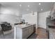 Bright kitchen with granite countertops, stainless steel appliances, grey cabinets, and an open view to the living room at 933 Canal West Dr, Brighton, CO 80603