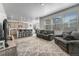 Open-concept living space flowing from a kitchen with a large rug, two sofas, and bright light at 933 Canal West Dr, Brighton, CO 80603