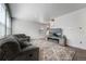 Bright living room featuring a stylish media center with fireplace and comfortable seating on neutral carpet at 933 Canal West Dr, Brighton, CO 80603