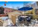 Inviting back deck with table, umbrella, and chairs, perfect for outdoor gatherings at 1368 N Gilpin St, Denver, CO 80218