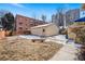 View of the backyard featuring a detached garage, and grass area at 1368 N Gilpin St, Denver, CO 80218