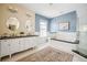 Stylish bathroom with dual sinks, tub, shower and patterned rug at 1368 N Gilpin St, Denver, CO 80218