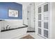 Modern bathroom featuring a glass-enclosed shower, soaking tub, and tiled floors at 1368 N Gilpin St, Denver, CO 80218