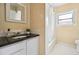 Bright bathroom with a tiled shower, modern vanity, and natural light at 1368 N Gilpin St, Denver, CO 80218