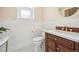 Charming bathroom with classic finishes, wainscoting, vanity, and modern fixtures at 1368 N Gilpin St, Denver, CO 80218