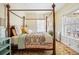 Bedroom features a four-poster bed, decorative rug, and natural light from the windows at 1368 N Gilpin St, Denver, CO 80218