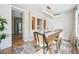 Dining room boasts a decorative rug, chandelier, and views into the kitchen with stainless steel appliances at 1368 N Gilpin St, Denver, CO 80218