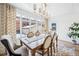 Bright dining room features a chandelier, light wood floors, large windows, and comfortable seating at 1368 N Gilpin St, Denver, CO 80218