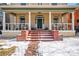 Inviting front porch with brick steps, rocking chairs, and white columns at 1368 N Gilpin St, Denver, CO 80218