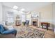 Sun-filled living room with a decorative fireplace, skylights, and hardwood flooring at 1368 N Gilpin St, Denver, CO 80218