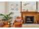 Charming living room showcasing a fireplace, stained glass windows, and hardwood floors at 1368 N Gilpin St, Denver, CO 80218