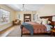 Comfortable main bedroom featuring a fireplace, large window, and hardwood floors at 1368 N Gilpin St, Denver, CO 80218