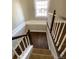 View of staircase with white banister and hardwood steps leading up to the second floor at 1368 N Gilpin St, Denver, CO 80218