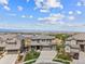 An aerial view of a home showing the neighborhood, a greenway and mountains in the distance at 16371 Jones Mountain Way, Broomfield, CO 80023