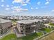 An elevated backyard view of a multi-story home featuring a patio, green lawn, and surrounding neighborhood at 16371 Jones Mountain Way, Broomfield, CO 80023