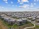 An aerial view showcases a well-planned residential community with manicured lawns and uniform rooftops at 16371 Jones Mountain Way, Broomfield, CO 80023