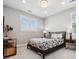 Cozy bedroom with neutral walls, an overhead light, and a large window at 16371 Jones Mountain Way, Broomfield, CO 80023