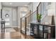 Inviting foyer with hardwood floors, staircase, and glass display cabinet at 16371 Jones Mountain Way, Broomfield, CO 80023