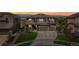 Beautiful two-story home with a three car garage, landscaped front yard and a stunning sunset at 16371 Jones Mountain Way, Broomfield, CO 80023